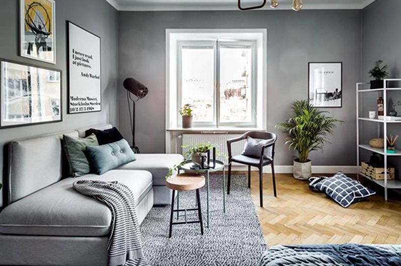 a living room with grey walls and a grey couch.