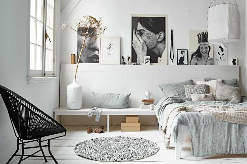 a bedroom with white walls and a white bed.