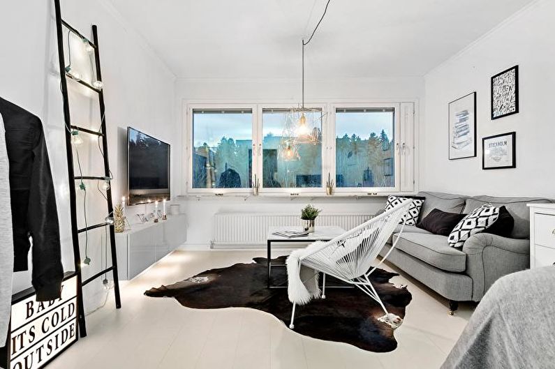 a white and black living room with a cowhide rug.