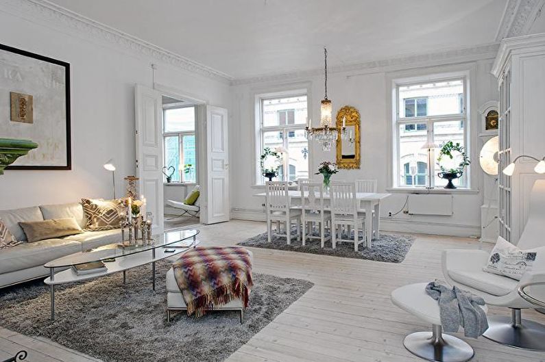 a living room with white furniture and white walls.