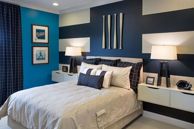 a blue and white bedroom with striped walls.