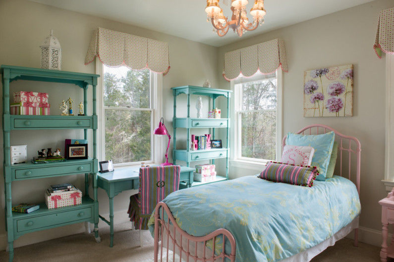 a blue and pink bedroom with a bed and dresser.