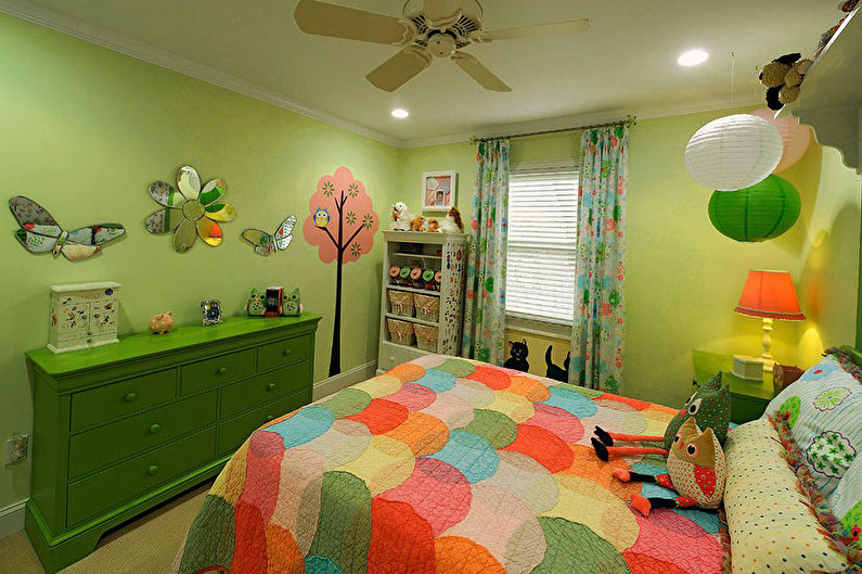 a child's bedroom with green walls and a colorful bed.