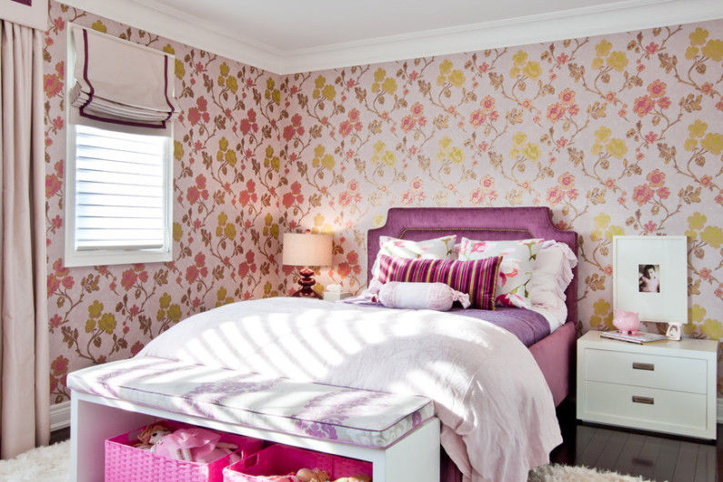 a girl's bedroom with purple and pink wallpaper.