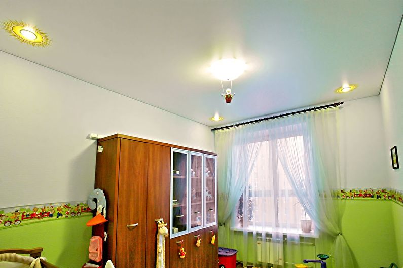 a child's room with green walls and a dresser.