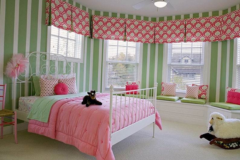 a girl's bedroom with green and pink striped walls.