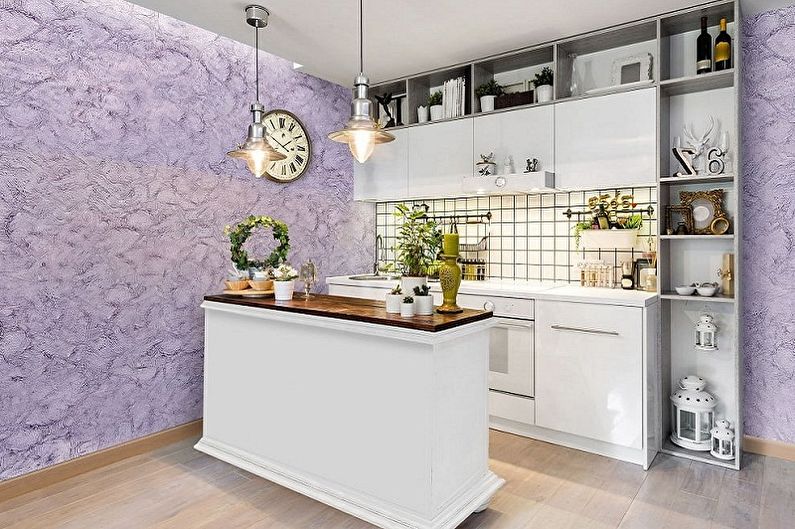 a kitchen with purple walls and white furniture.