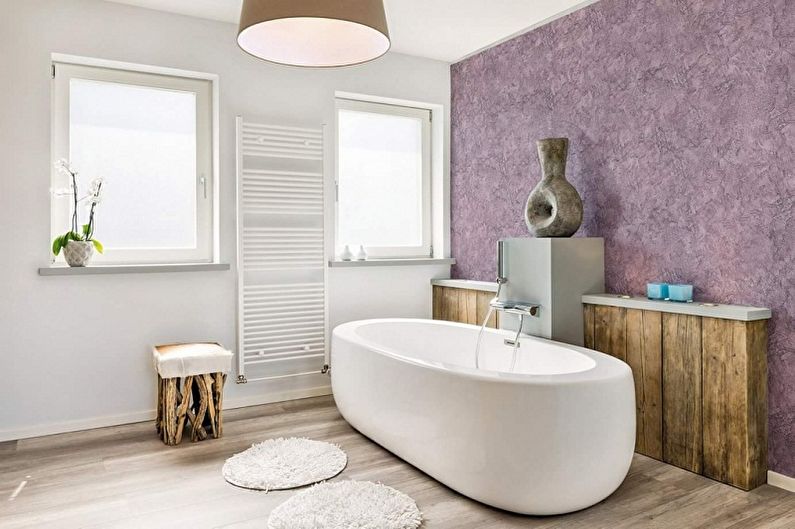 a bathroom with purple walls and wooden floors.