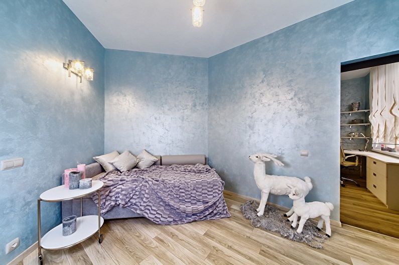 a bedroom with blue walls and a deer on the floor.