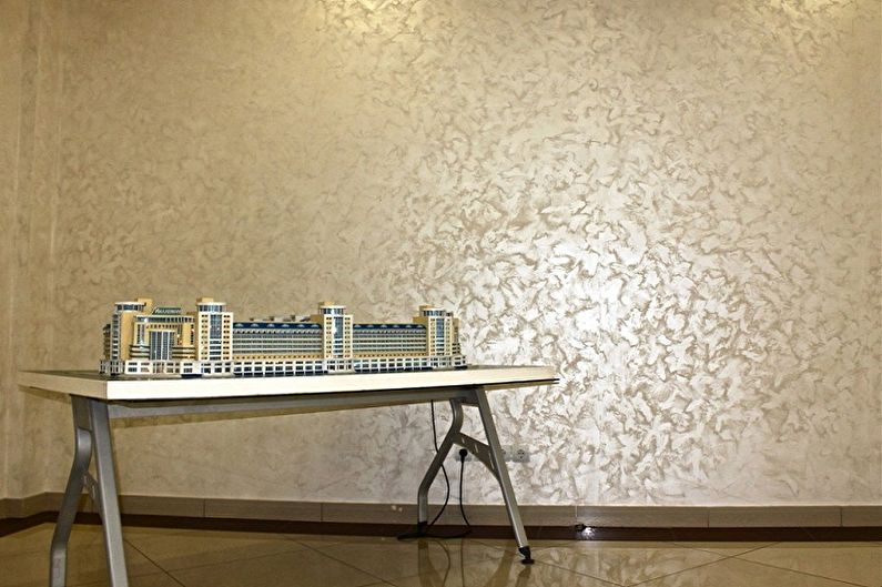 a table with a model of a building in front of it.