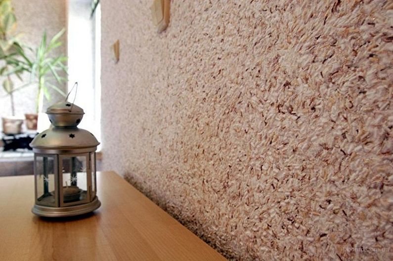 a wooden table with a lamp on it next to a wall.