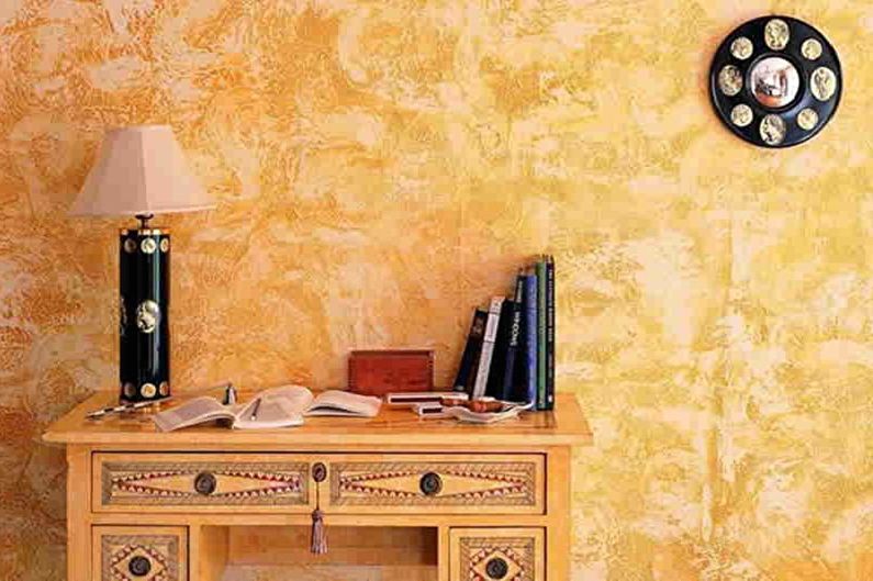 a room with a yellow painted wall and a desk.