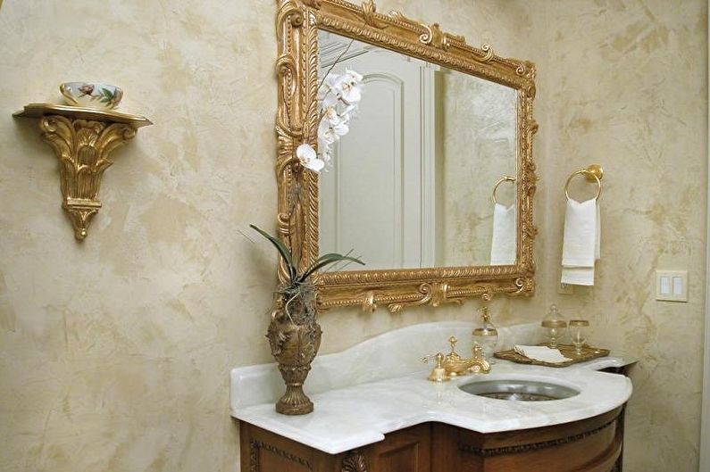 a bathroom with an ornate vanity and mirror.