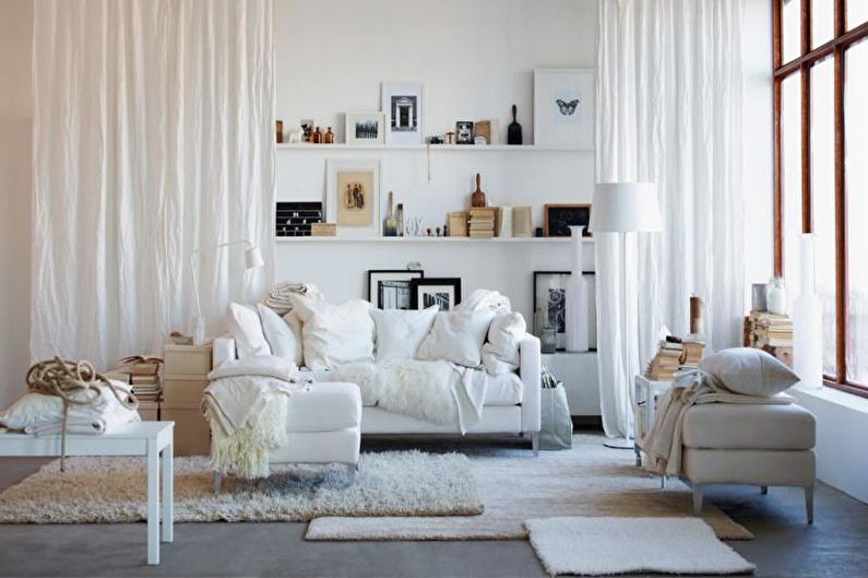 a white living room with lots of white furniture.