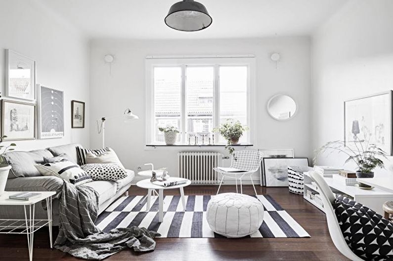 a white and black living room with a striped rug.