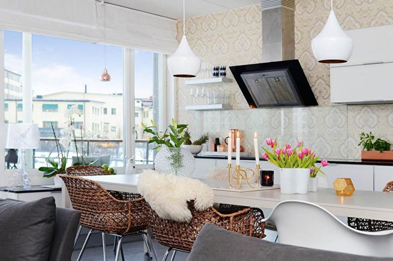 a white kitchen and dining room with a view of the city.