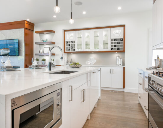 a white kitchen with stainless steel appliances.