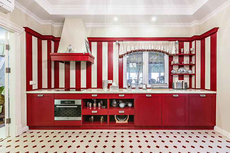 A kitchen with red and white striped cabinets.