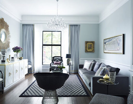 A living room with grey walls and black furniture.