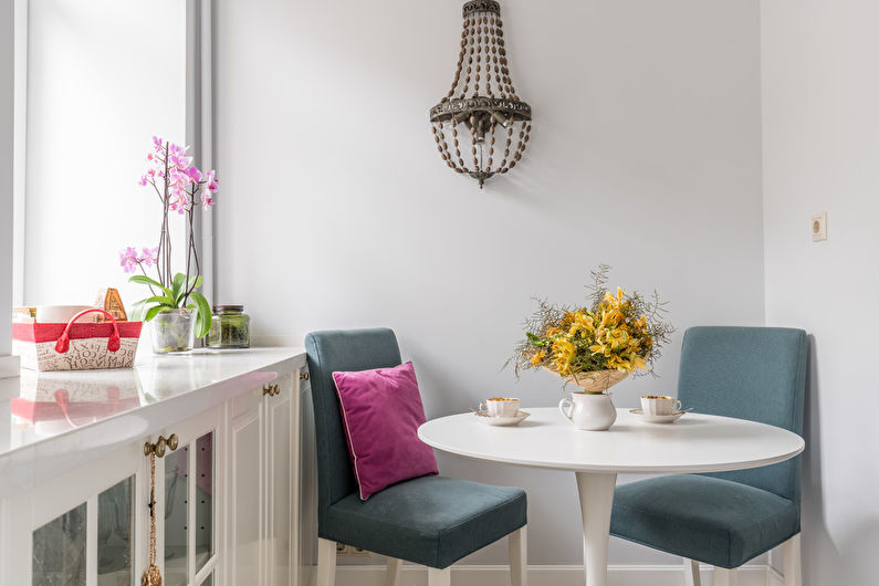 A small kitchen with a table and chairs.