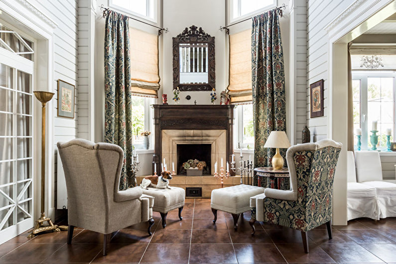 A living room with a fireplace and chairs.