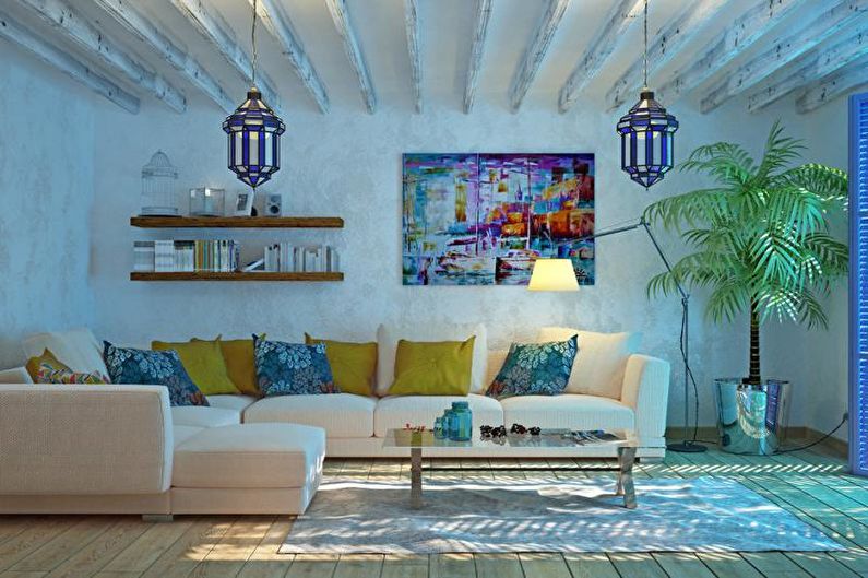 A living room with blue walls and white furniture.