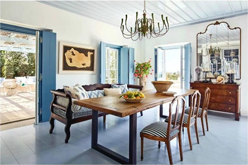 A dining room with blue walls and a wooden table.