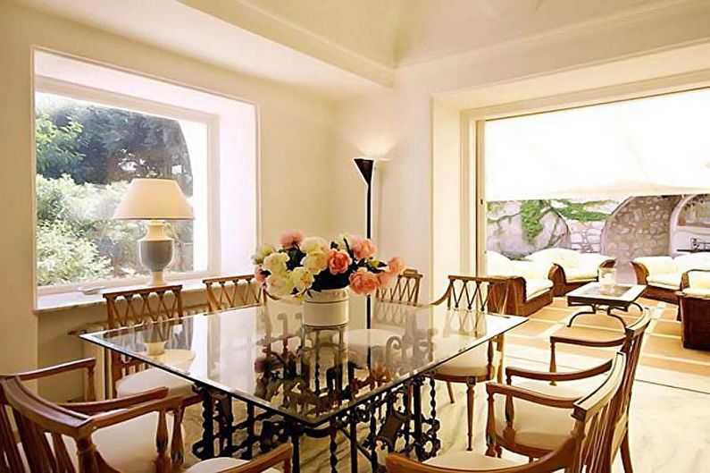 A dining room with a glass table and chairs.