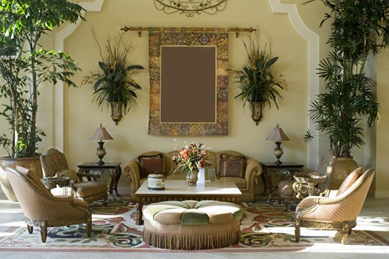 A living room with ornate furniture and a large mirror.