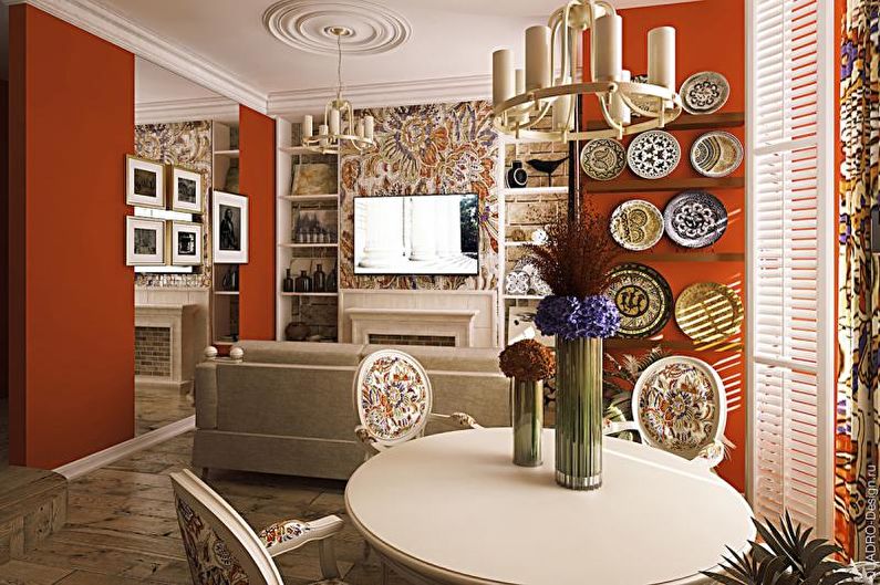 A dining room with orange walls and a white table and chairs.