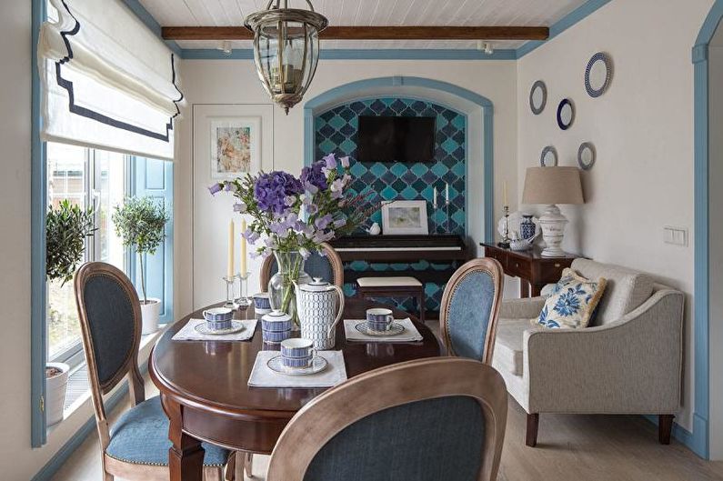 A dining room with blue chairs and a piano.