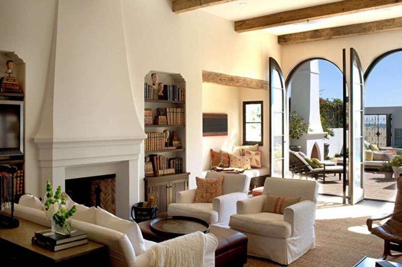 A living room with a fireplace and large windows.