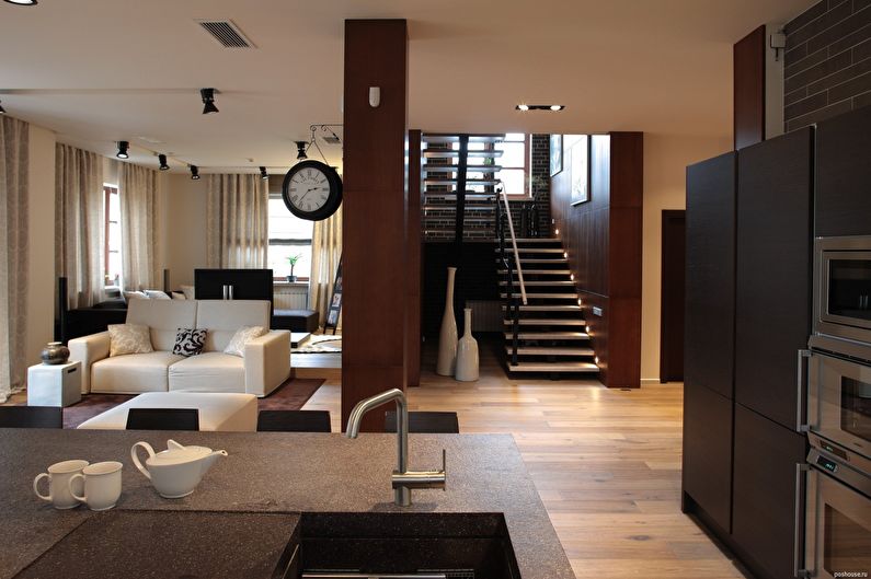 A living room with white furniture and a fireplace.