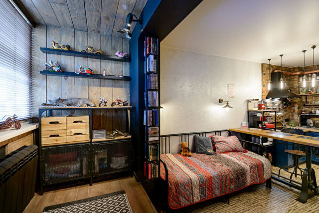 A room with a bed, desk and bookshelves.