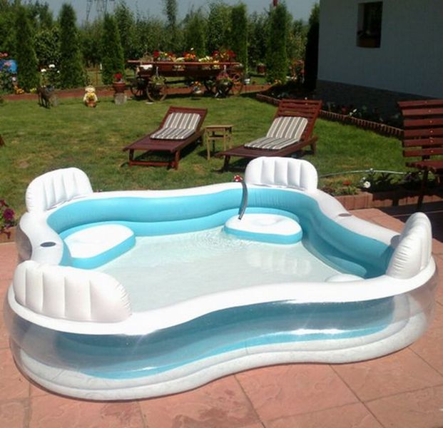 An inflatable swimming pool in a backyard.