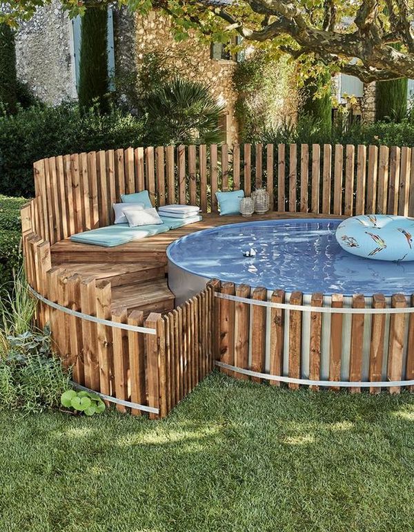 A wooden pool with a wooden deck around it.