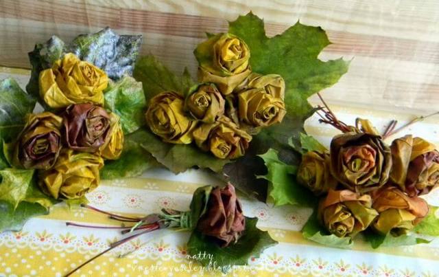 A bunch of dried roses and leaves on a table.