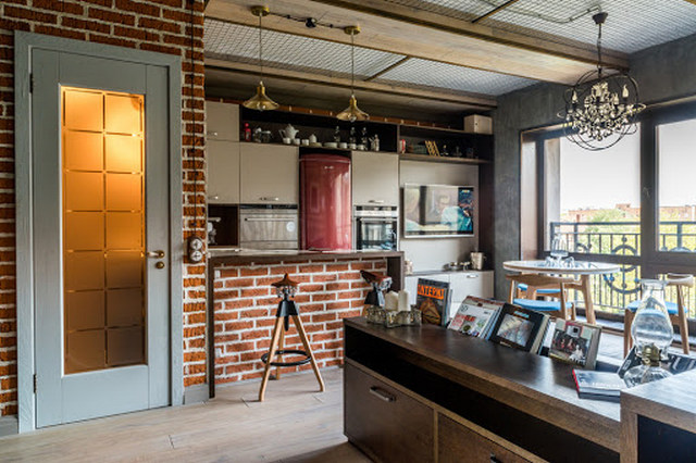 A kitchen with brick walls and a balcony.