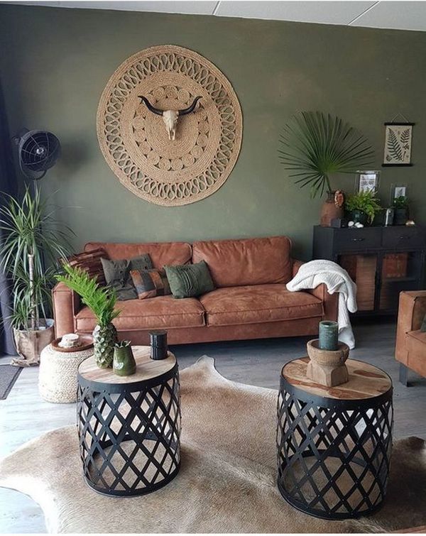 A living room with brown leather furniture and a large wall clock.