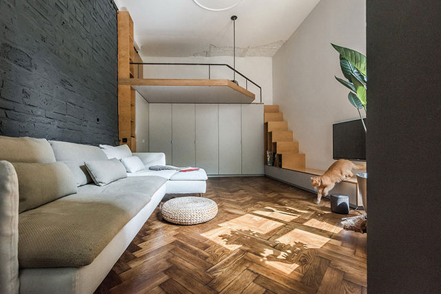 A living room with stairs and a couch.