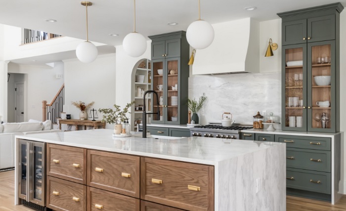 A kitchen with marble counter tops and wooden cabinets.