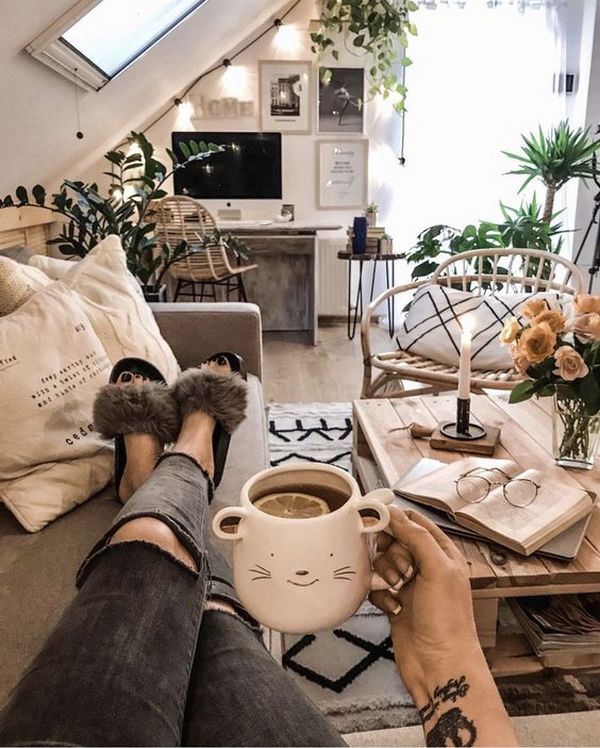 A person holding a cup of coffee in a living room.