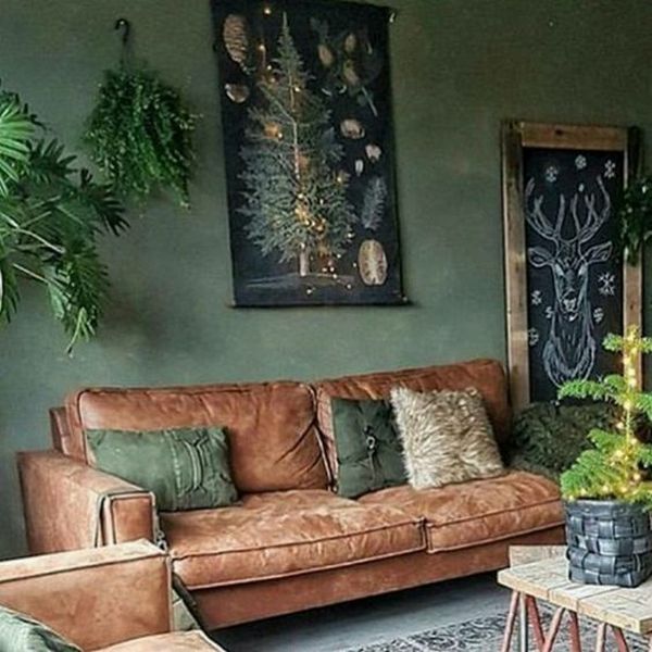 A living room with green walls and brown furniture.