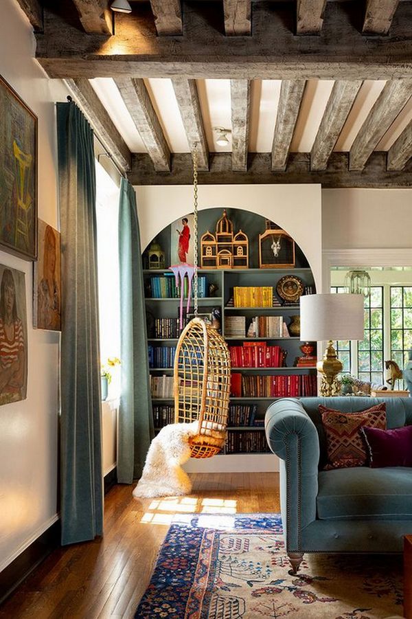 A living room with wooden beams and a blue couch.