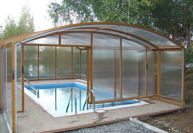 A swimming pool with a glass enclosure.