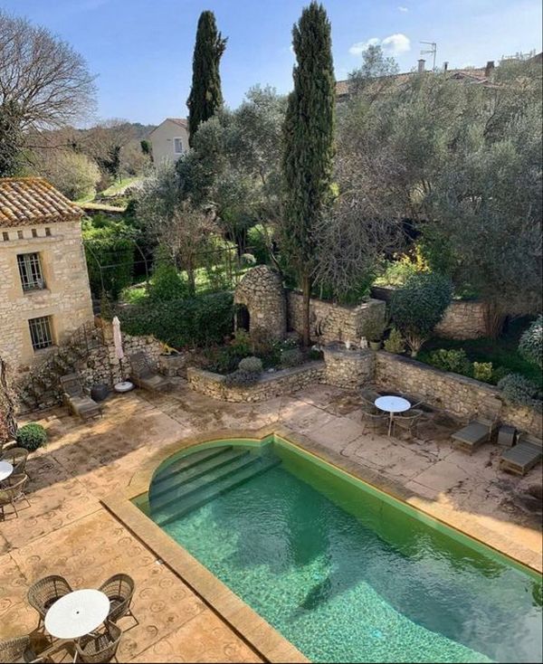 A swimming pool in the middle of an old stone house.