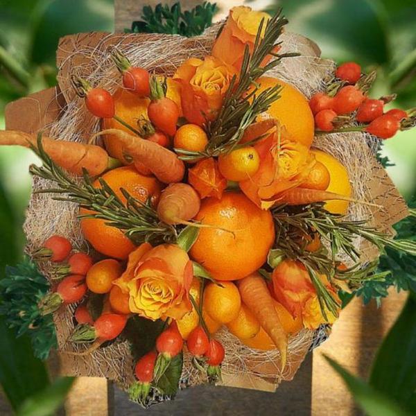 A bouquet of oranges and roses in a basket.