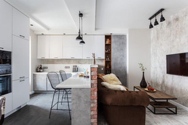 A kitchen and living room in a modern apartment.