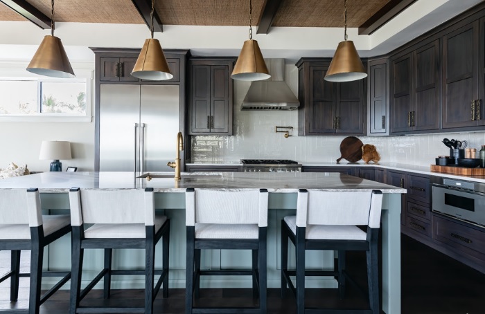 A kitchen with a center island and bar stools.