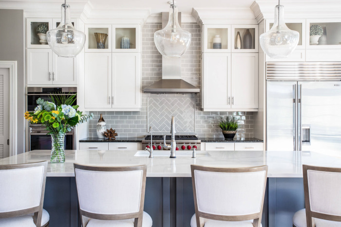 A kitchen with white cabinets and a center island.